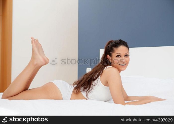 Brunette young woman resting in her bed