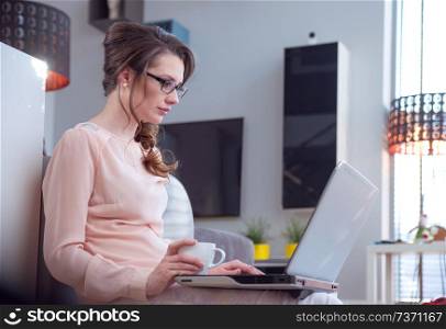 Brunette young woman working with the laptop