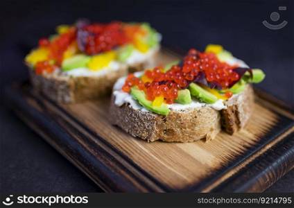 bruschetta sandwiches with avocado and red caviar