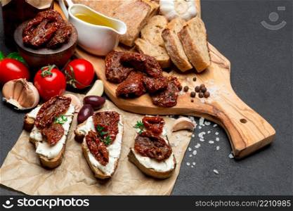 bruschetta with Canned Sundried or dried tomato halves and cream cheese on craft pepper. bruschetta with Canned Sundried or dried tomato halves on craft pepper