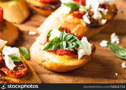 Bruschetta with olive oil, sundried tomatoes, feta and fresh basil