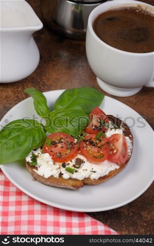 Bruschetta with ricotta and cherry tomatoes seasoned spices, basil