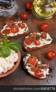 Bruschetta with ricotta and cherry tomatoes seasoned spices, basil