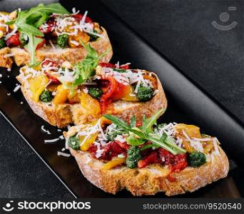 bruschetta with roasted peppers, pesto and parmesan cheese