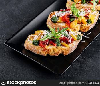 bruschetta with roasted peppers, pesto and parmesan cheese