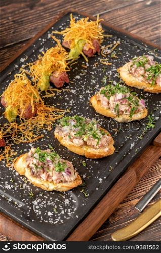 bruschetta with seafood made with Asian flavors on a stone cutting board