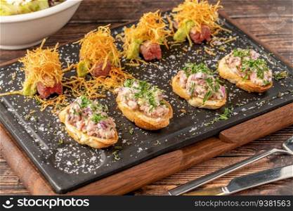 bruschetta with seafood made with Asian flavors on a stone cutting board
