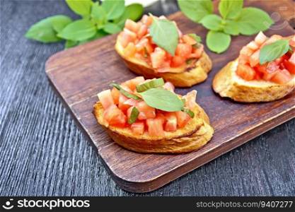 Bruschetta with tomatoes and basil on a wooden table background