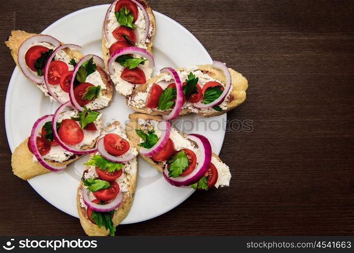 bruschetta with tomatoes, cheese, onions and parsley