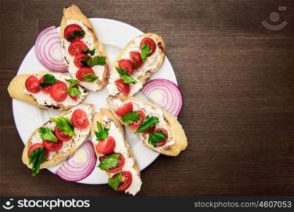 bruschetta with tomatoes, cheese, onions and parsley