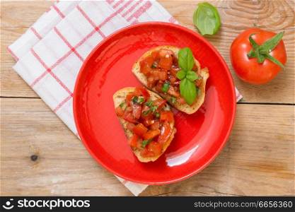 Bruschetta with tomatoes on a wooden board.. Bruschetta with tomatoes on a wooden board