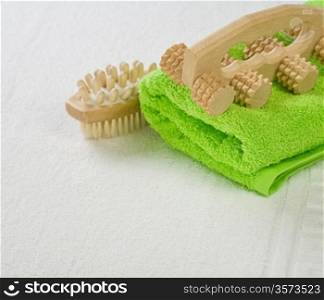 brush and massager with green towel