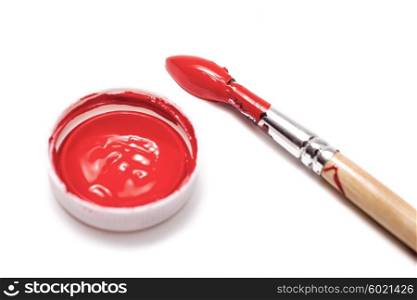 Brush and red paint isolated on white background
