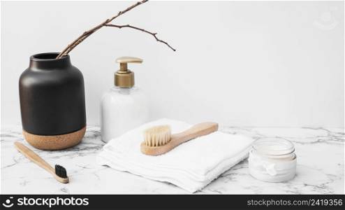 brush towel moisturizing cream cosmetic bottle marble surface