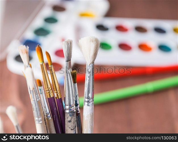 Brushes for painting on the background of boxes of paints
