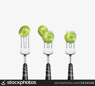brussels pierced by forks, isolated on white background
