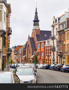 Brussels traditional architecture street. Cars parked by the buildings along the road. Brussels, Belgium