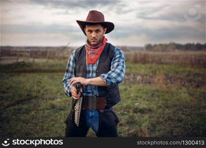 Brutal cowboy with revolver, gunfight on texas ranch, western. Vintage male person with gun, wild west. Brutal cowboy with revolver, gunfight on ranch