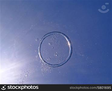 Bubble ring from the air rises upwards the sun.