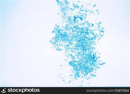 Bubbles in blue water against a white background