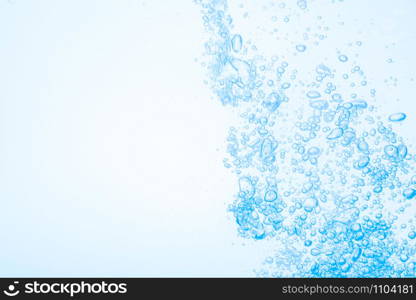 Bubbles in blue water against a white background