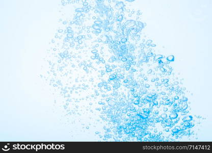 Bubbles in blue water against a white background