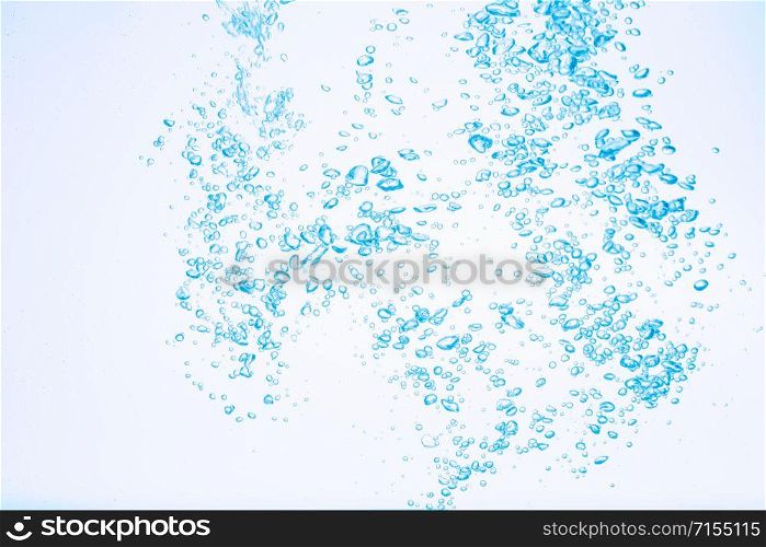 Bubbles in blue water against a white background