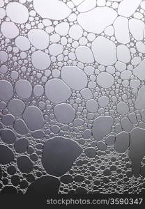 Bubbles of water on grey surface