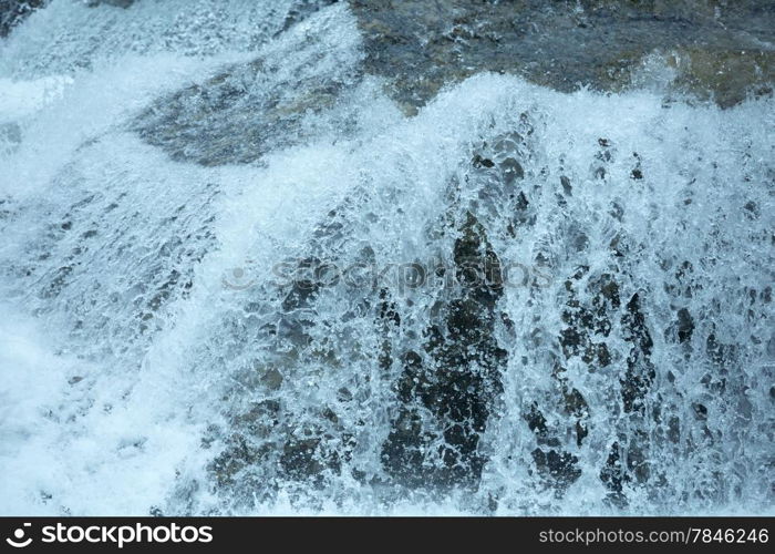 Bubbling stream of water closeup (nature background).