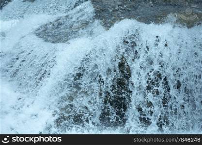 Bubbling stream of water closeup (nature background).