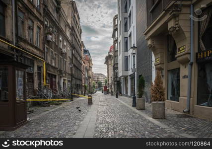 BUCHAREST, ROMANIA - 07.20.2018. Old Center of Bucharest, Romania in a cloudy summer morning. Sullen and unpleasant atmosphere, dirty streets and shabby buildings.. Old Center of Bucharest, Romania