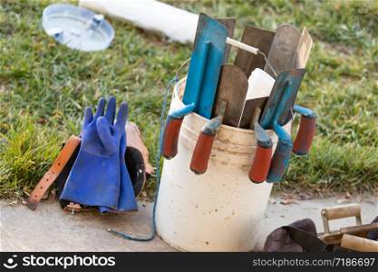 Bucket of Cement Trowels and Tools