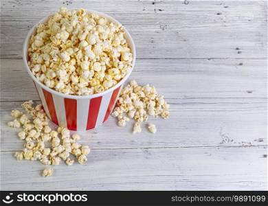 bucket of popcorn on light wooden boards