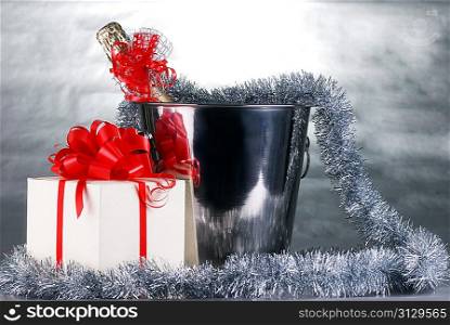 bucket with champagne bottle and garland. christmas symbols