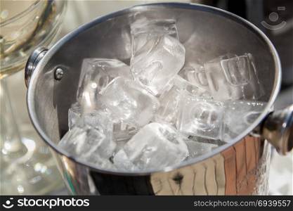 Bucket with ice cubes. A bucket with ice cubes close-up, top view.