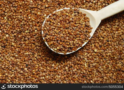 Buckwheat and wooden spoon. Buckwheat