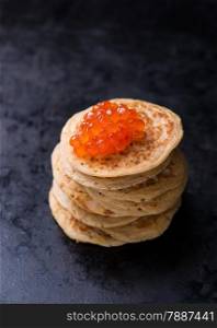 Buckwheat blini with red caviar and sour cream, selective focus