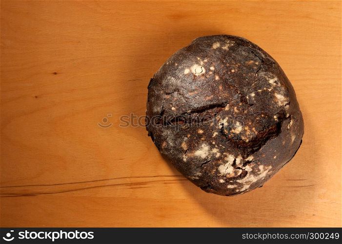 buckwheat bread with prunes on wooden background