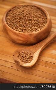 buckwheat . buckwheat at wooden plate on wooden background