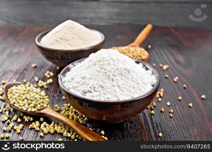 Buckwheat flour from green and brown cereals in two bowls, groats in spoons and on the table against the background of a dark wooden board