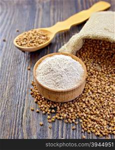 Buckwheat flour in a wooden bowl, buckwheat in a bag on a dark wooden board