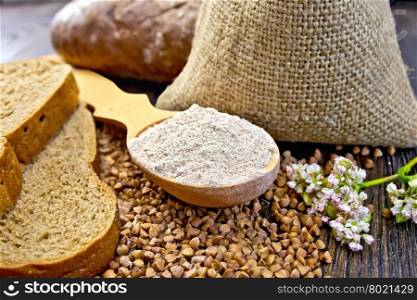 Buckwheat Flour in a wooden spoon buckwheat in a bag on the table, slices of bread, buckwheat flower on the background of wooden boards