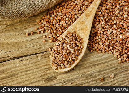 buckwheat groats and wooden spoon