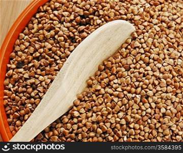 buckwheat groats in a bowl on a wooden table