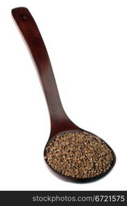 Buckwheat in a wooden spoon on a white background