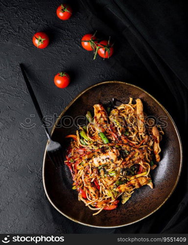 Buckwheat noodle in a black bowl on chicken fillet