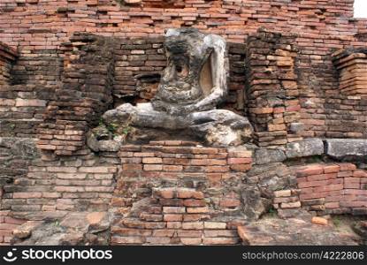 Buddha and brick wall in wat, Sukhotai, Thailand