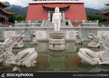 Buddha and dragons in fountain near buddhist temple in Dali, China