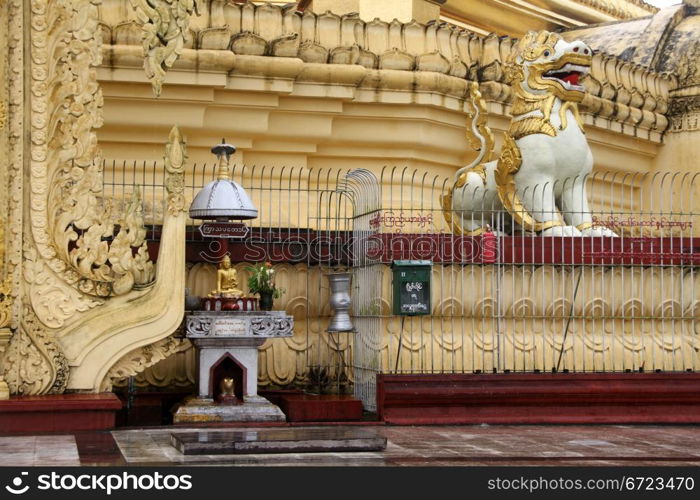 Buddha and lion on the base of Ne Vin pagoda in Yangon, Myanmar