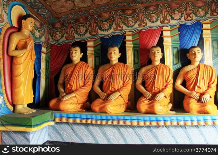 Buddha and seated monks in Mulkirgala cave, Sri Lanka